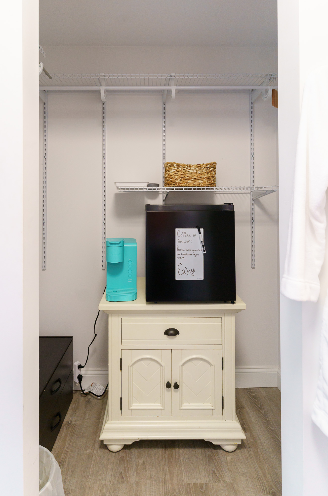 Closet and mini fridge welcome station for guests