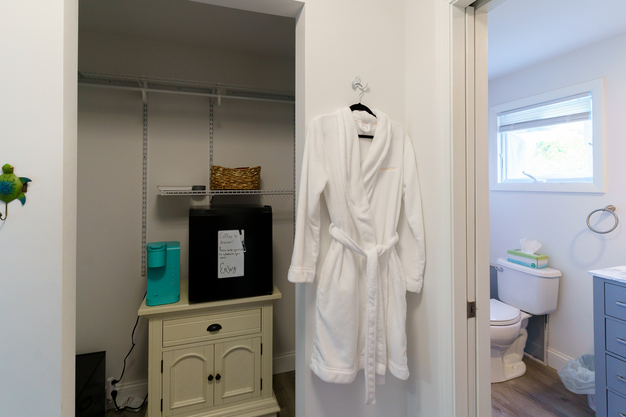 Bathrobe hanging beside the ensuite bathroom door