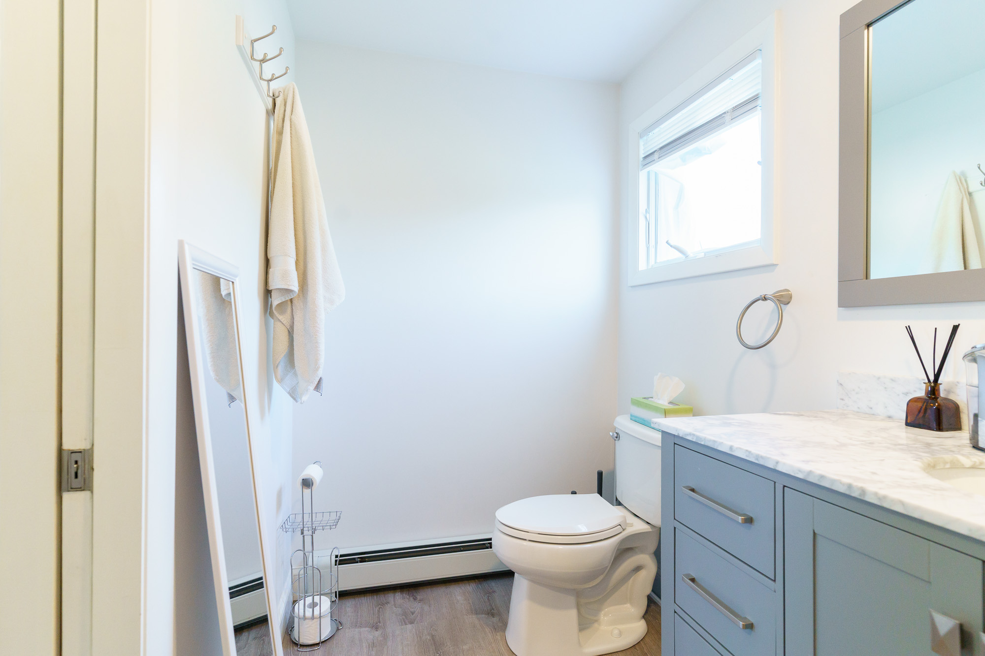 Guest bathroom with toilet and towel hooks