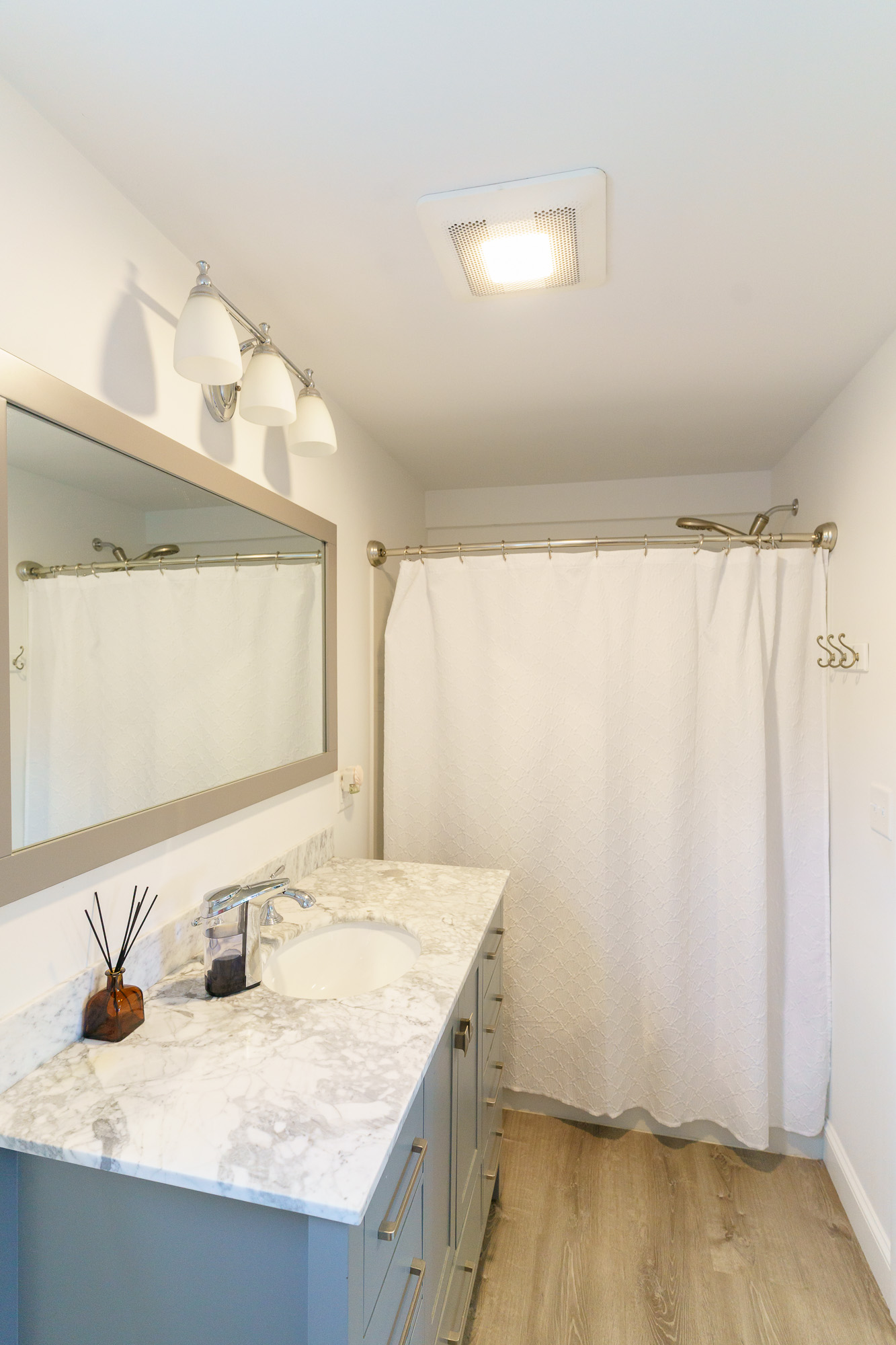 Closet with folded towels and robe hanging