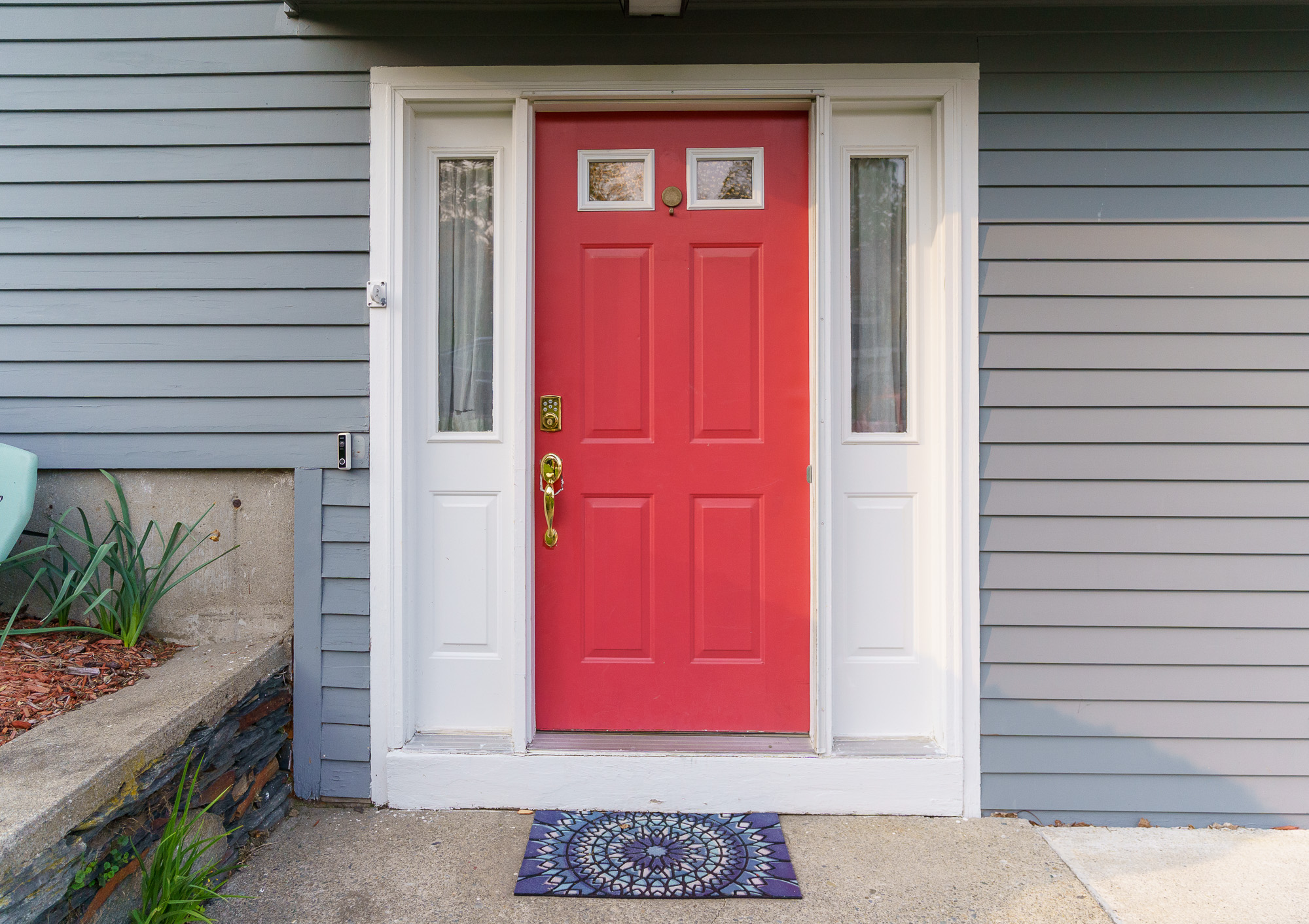 Red front door with sidelight windows