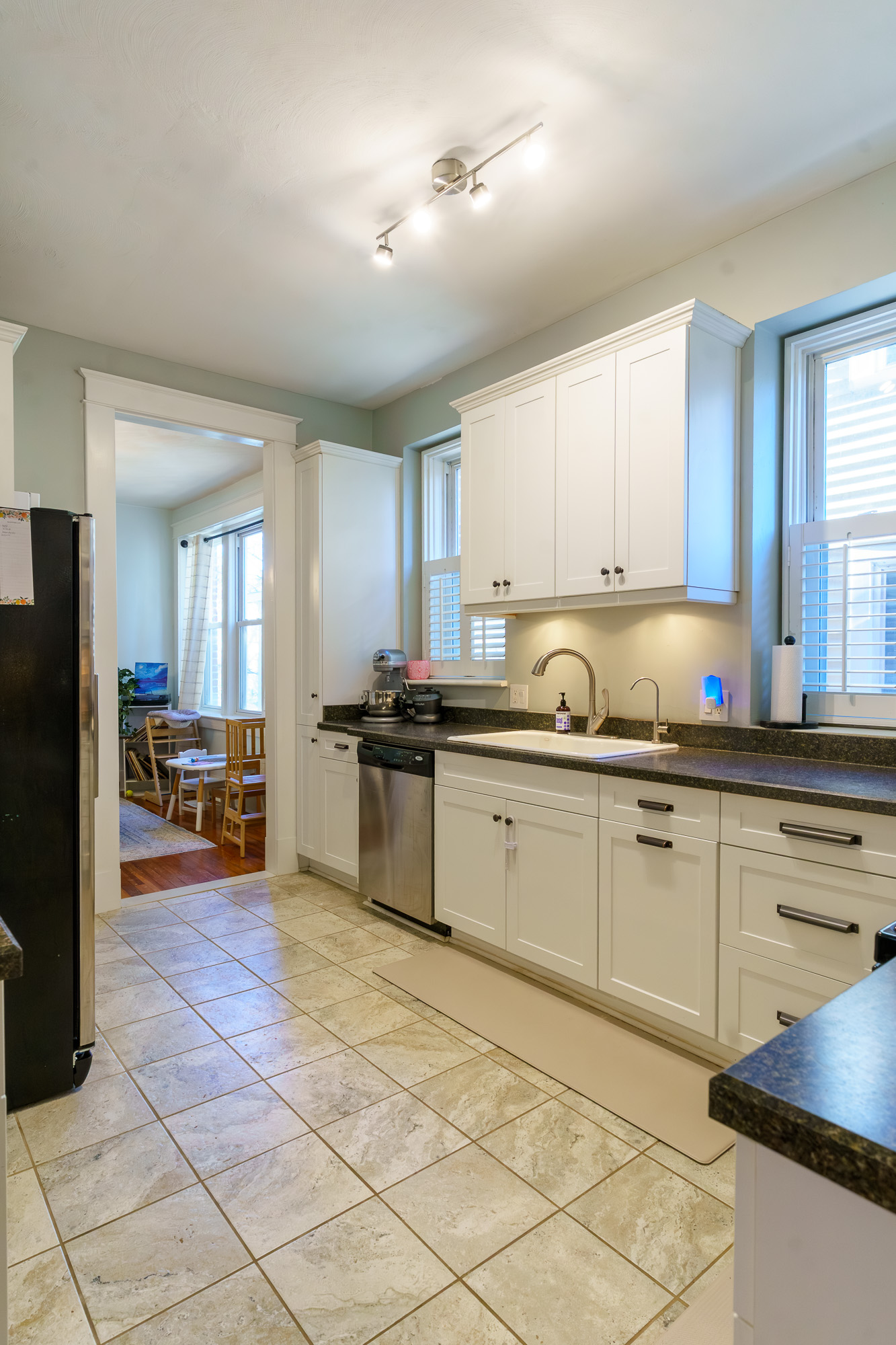 Kitchen with white cabinetry and tile floor