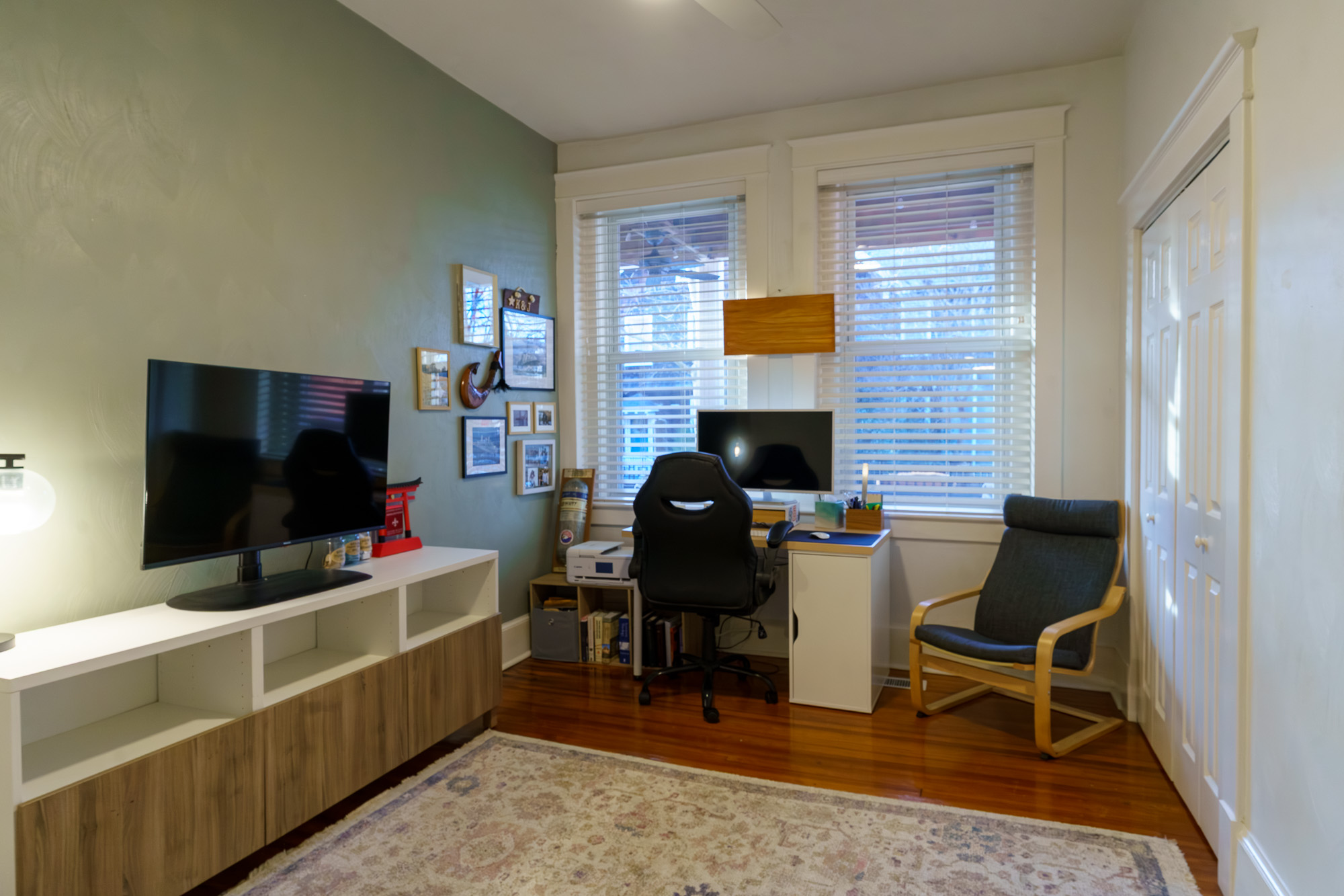 Home office with wall-mounted television and desk
