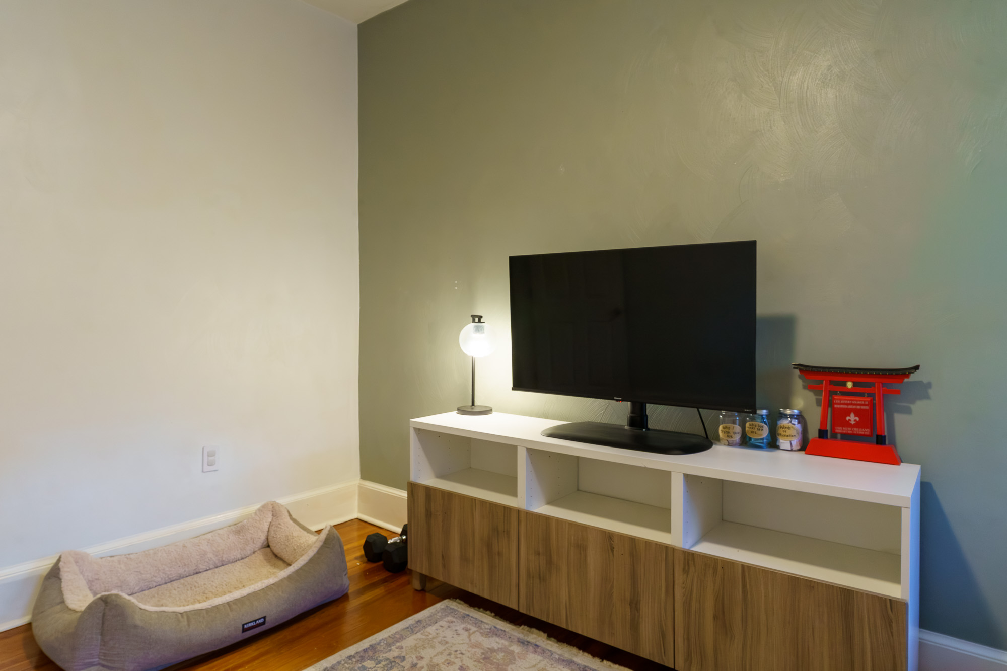 Home office media console with dog bed and decor